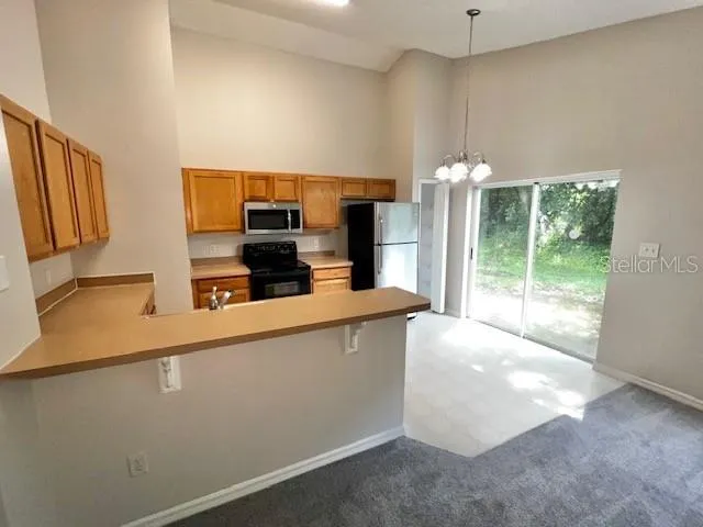 a kitchen with cabinets and stainless steel appliances