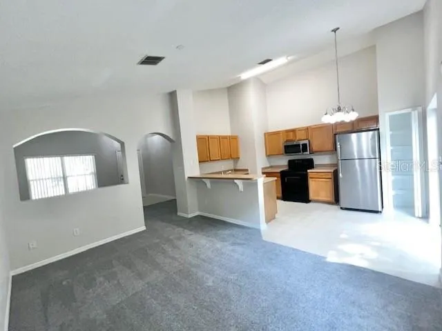 a kitchen with a refrigerator and a stove top oven