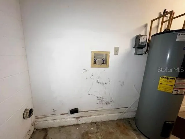 a view of storage and utility room with a window