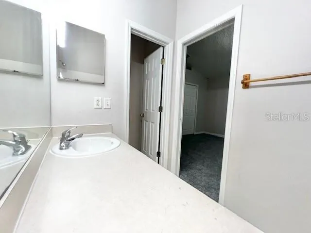 a en suite bathroom with a sink and mirror