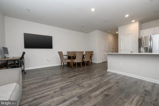 a view of a dining room with furniture and a flat screen tv