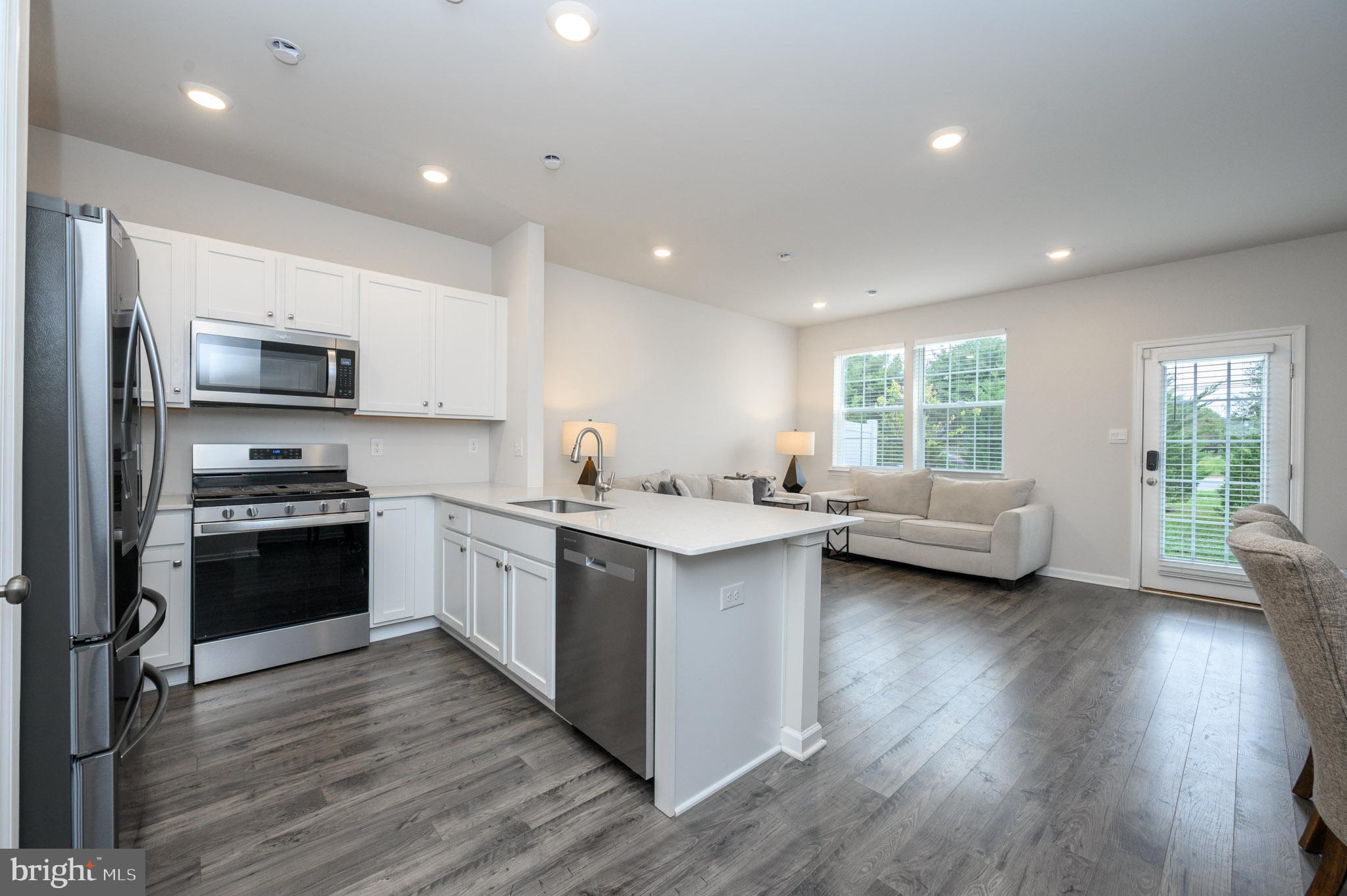 40 Nelsons Way Westampton, NJ 08060 - Photo 5 of 34 a kitchen with stainless steel appliances granite countertop wooden floors a stove and a sink
