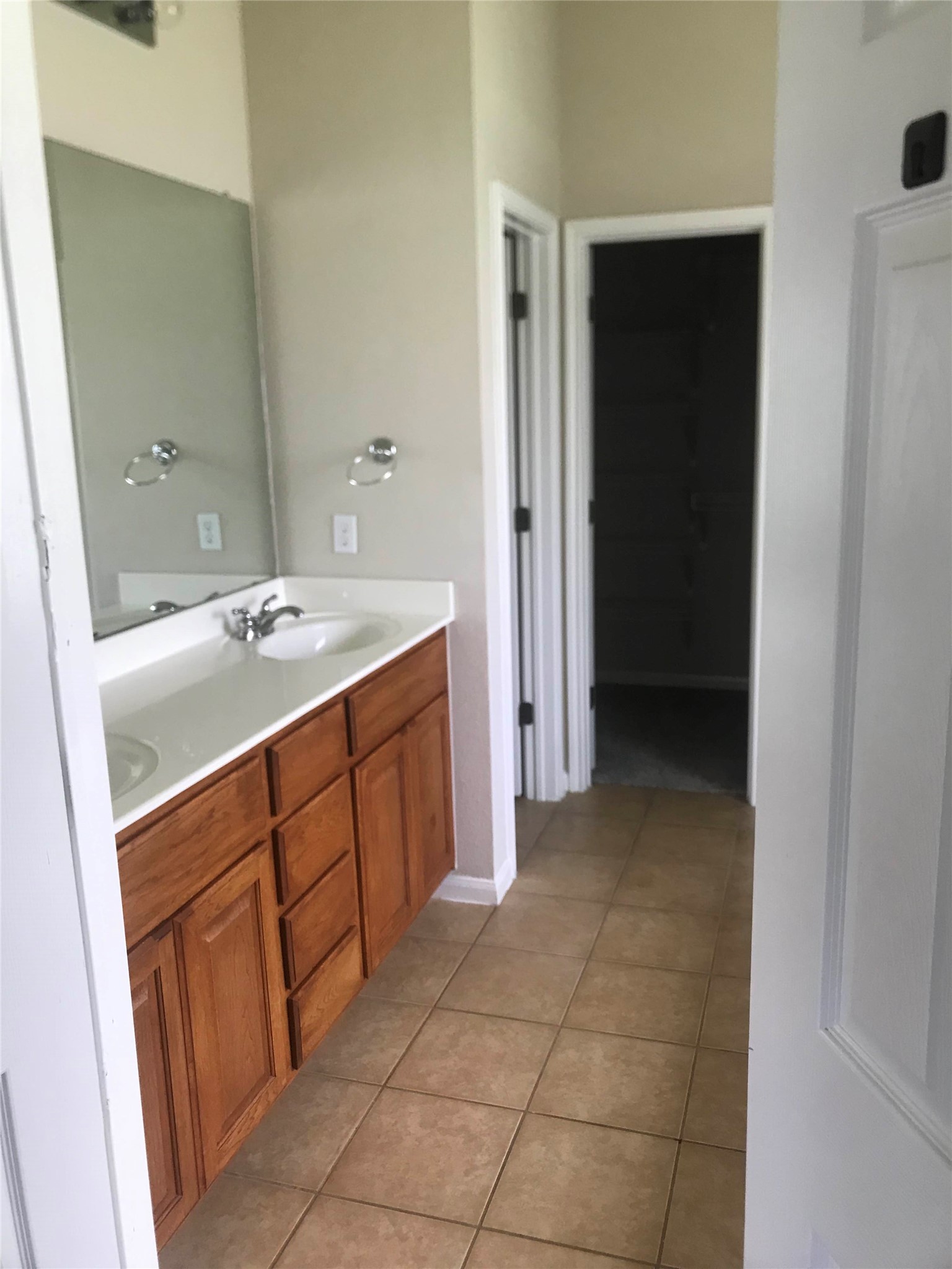 913 Rochester Castle Way Pflugerville, TX 78660 - Photo 17 of 25 Double vanity with ample storage and tiled flooring provides a practical and polished bathroom space.