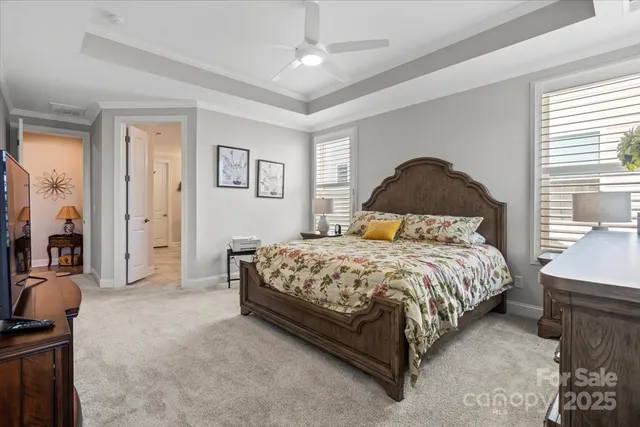 a bedroom with a bed and a chandelier