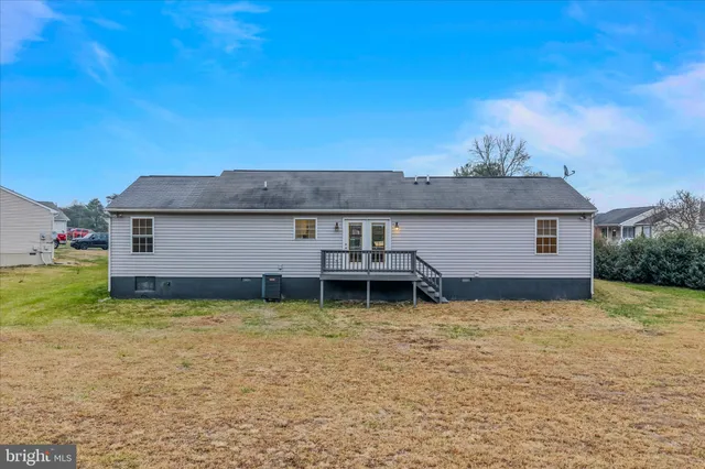 a view of a house with a yard and tree