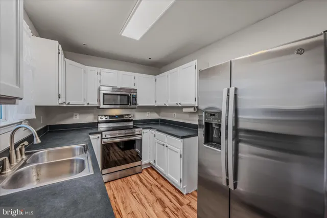 a kitchen with a sink stove and refrigerator