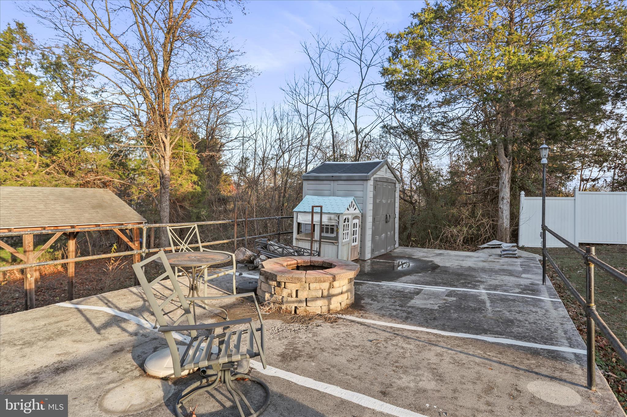 1064 Strasburg Road Front Royal, VA 22630 - Photo 44 of 48 a view of a patio with table and chairs with wooden fence and floor