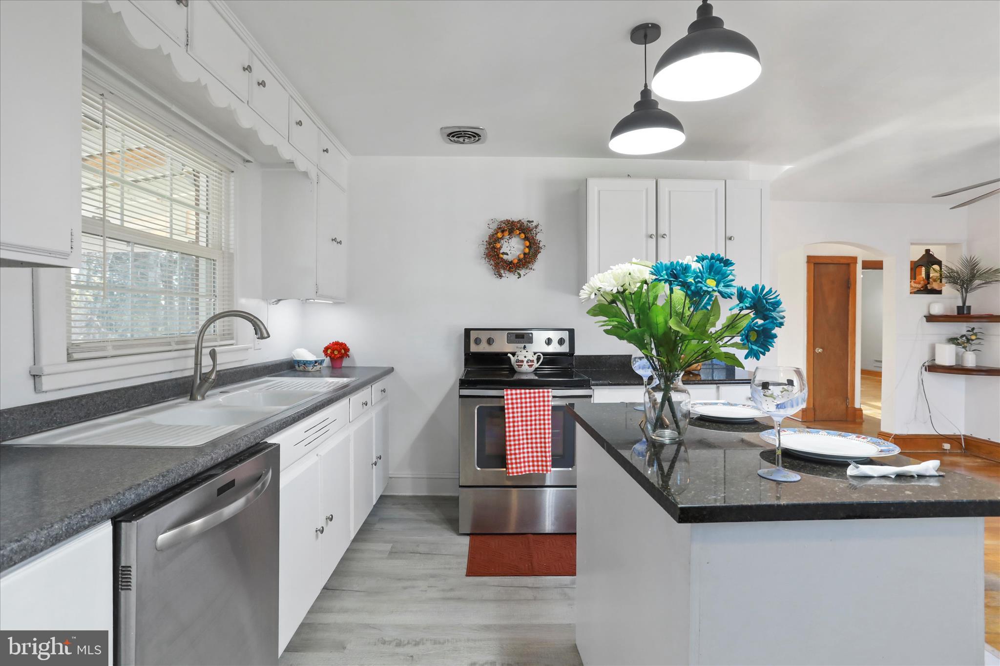 1064 Strasburg Road Front Royal, VA 22630 - Photo 10 of 48 a kitchen with kitchen island granite countertop a sink a counter space and a window