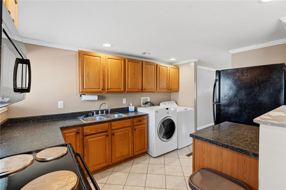 3890 Endover Road Dayton, OH 45439 - Photo 16 of 26 Functional kitchen and laundry area with practical appliances and ample cabinetry.