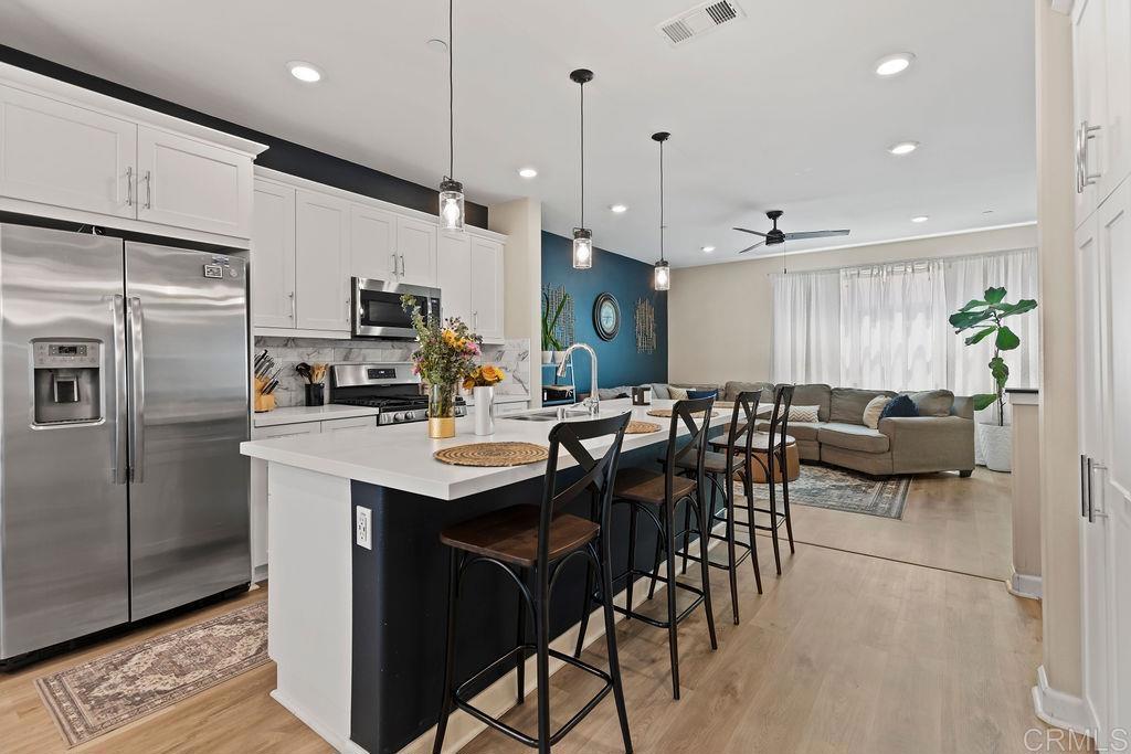 a kitchen with counter space appliances and a dining table