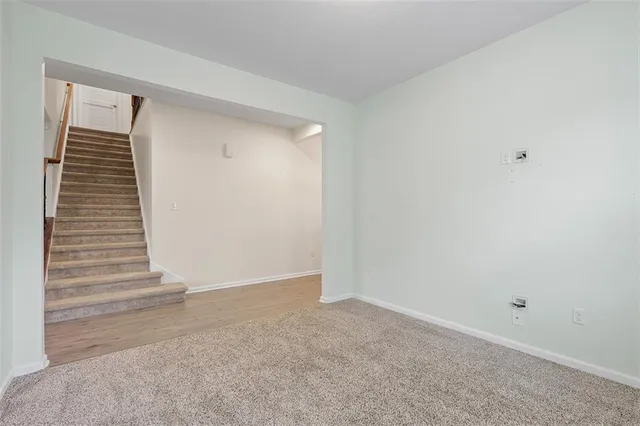 a view of an empty room with stairs