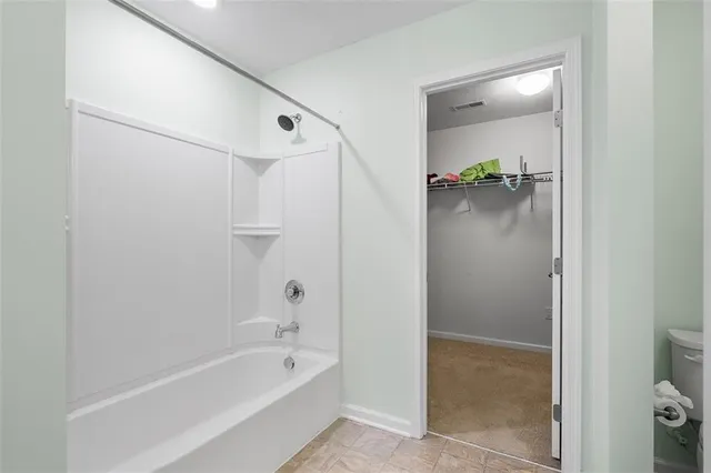 a bathroom with a bathtub and shower
