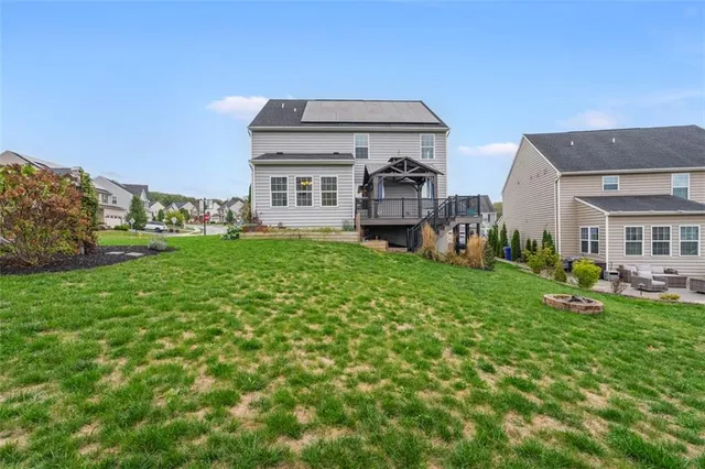 a view of a house with a yard and sitting area