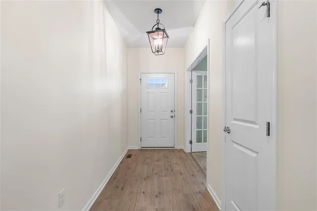 a view of a hallway with wooden floor and staircase