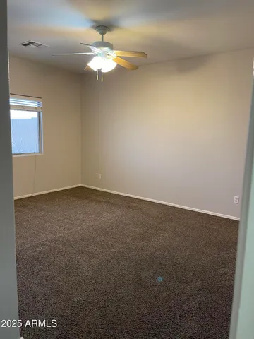 an empty room with a fan