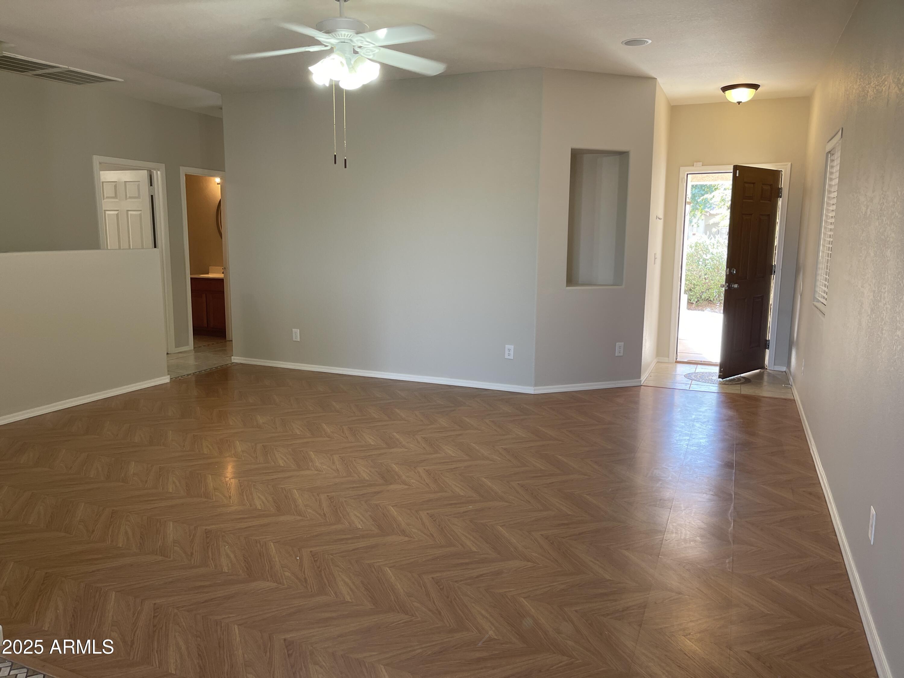 1426 East Ave Isabela Casa Grande, AZ 85122 - Photo 2 of 24 a view of an empty room with wooden floor and a chandelier