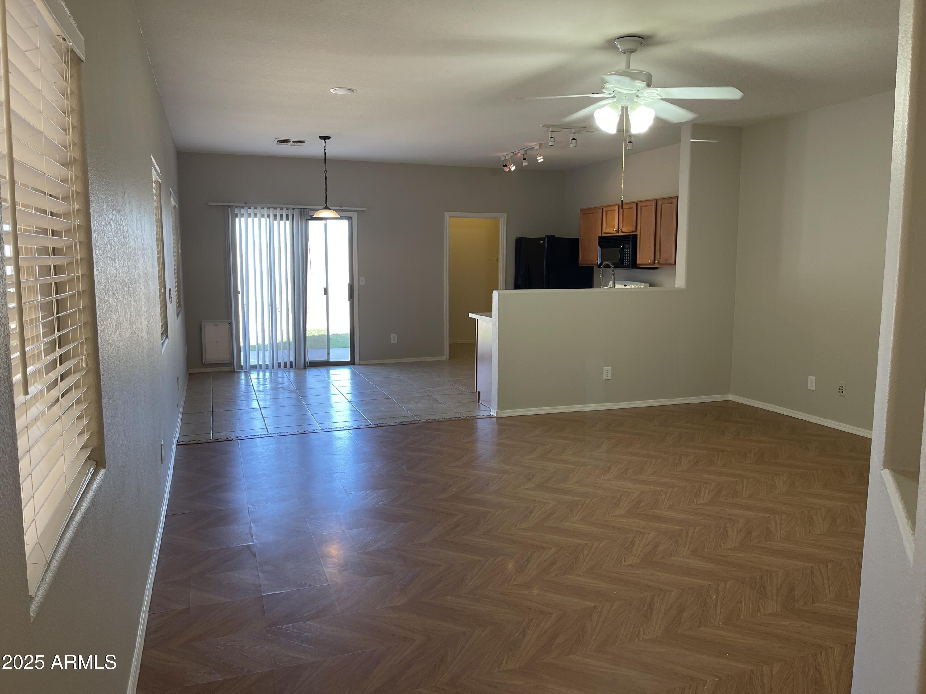 1426 East Ave Isabela Casa Grande, AZ 85122 - Photo 3 of 24 an empty room with wooden floor and windows