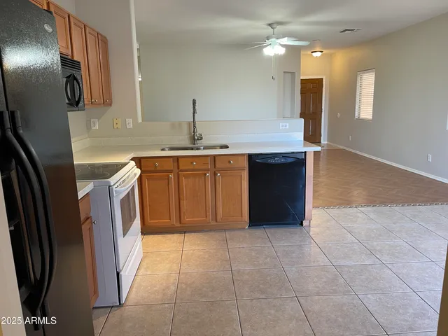 a kitchen with stainless steel appliances granite countertop a sink and a refrigerator