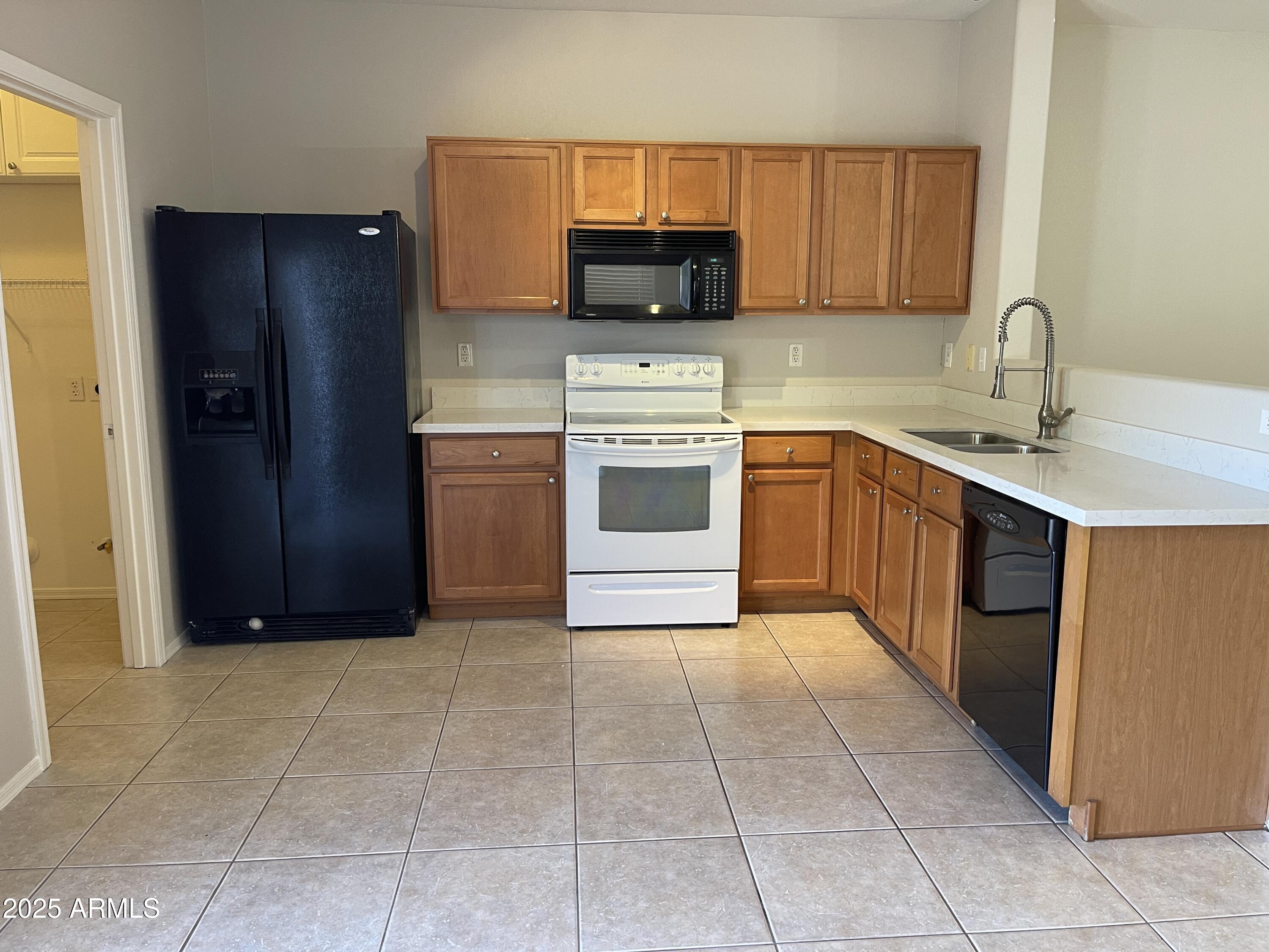 1426 East Ave Isabela Casa Grande, AZ 85122 - Photo 7 of 24 a kitchen with stainless steel appliances granite countertop a refrigerator and a sink