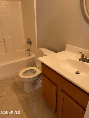 a bathroom with a sink mirror vanity and toilet