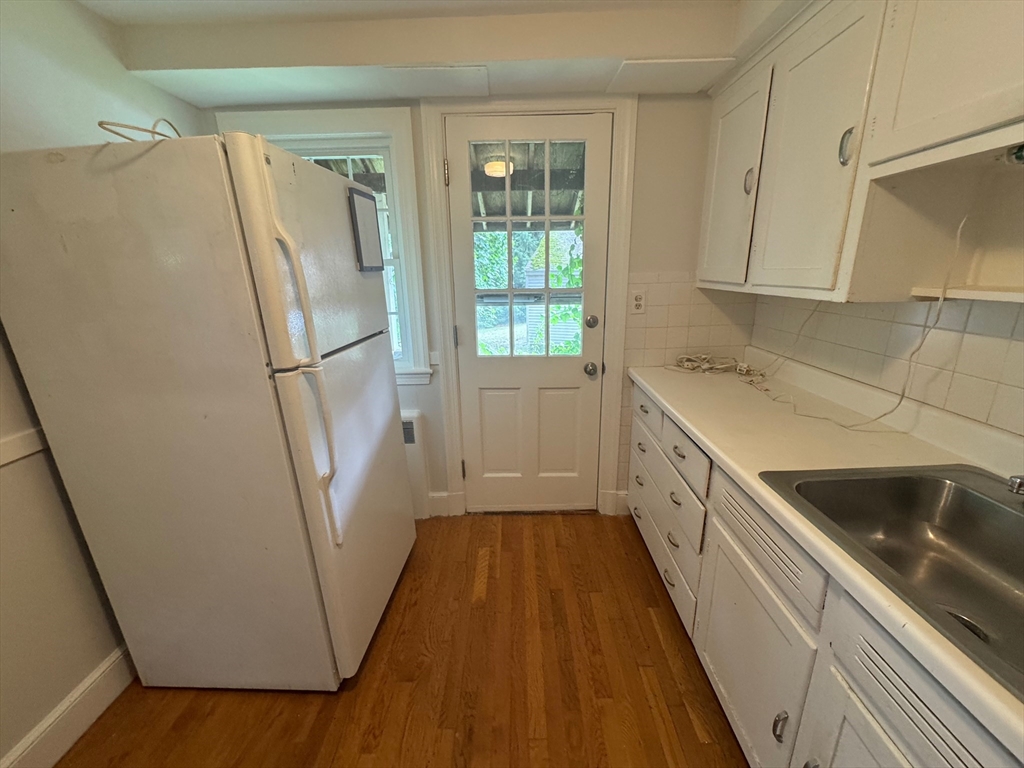 161 Hunnewell Street, Unit 1 Needham, MA 02494 - Photo 6 of 13 a kitchen with sink a refrigerator and window