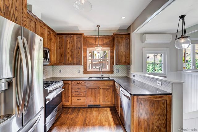 a kitchen with a sink a center island cabinets and a window