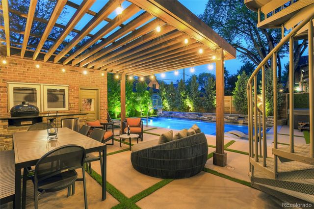 a view of a house with backyard water fountain and sitting area