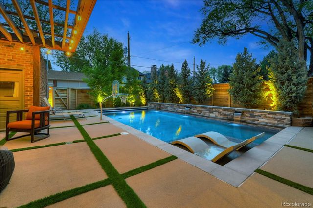 a view of a house with pool and sitting area