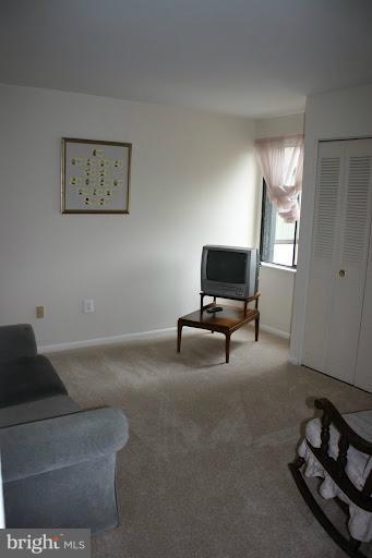 9822 Georgia Avenue, Unit 19201 Silver Spring, MD 20902 - Photo 12 of 14 a living room with furniture and a flat screen tv