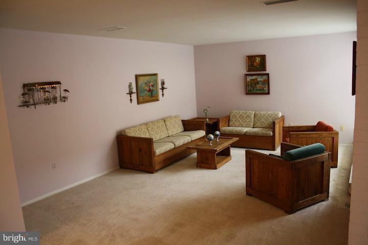 9822 Georgia Avenue, Unit 19201 Silver Spring, MD 20902 - Photo 2 of 14 a living room with furniture and a couch