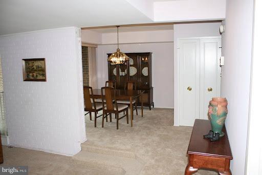 9822 Georgia Avenue, Unit 19201 Silver Spring, MD 20902 - Photo 3 of 14 a dining room with furniture and a potted plant