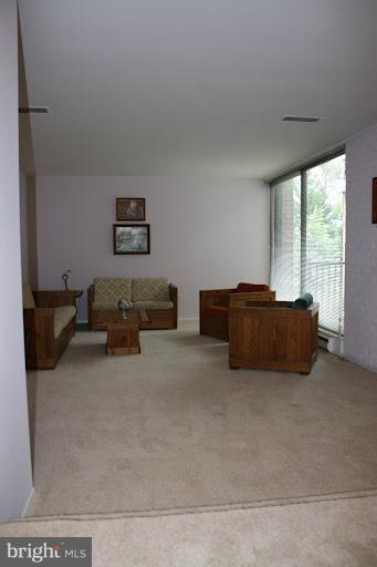 9822 Georgia Avenue, Unit 19201 Silver Spring, MD 20902 - Photo 9 of 14 a living room with furniture and a flat screen tv