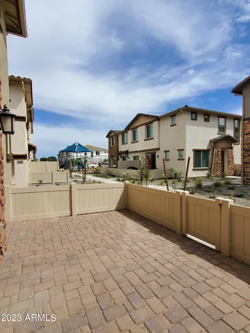 a large kitchen with stainless steel appliances a sink and cabinets