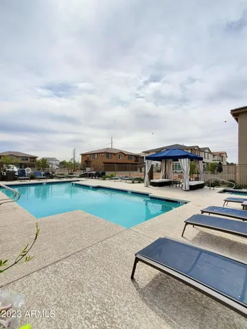 a view of swimming pool with seating area and hardwood floor