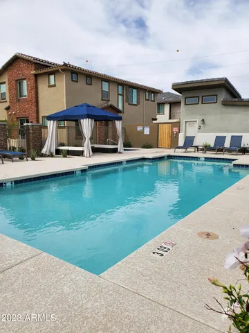 a front view of a house with swimming pool yard and outdoor seating