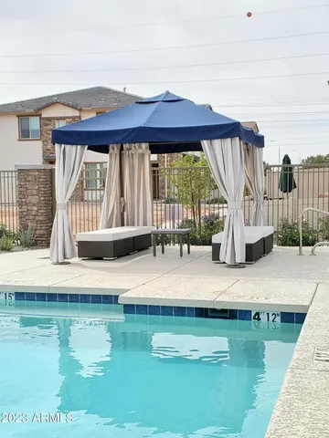 a view of swimming pool with a patio and a yard