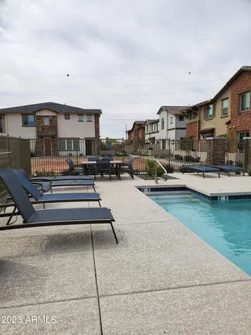 a swimming pool view with a outdoor seating