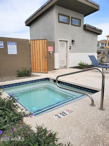 a view of a backyard patio and swimming pool