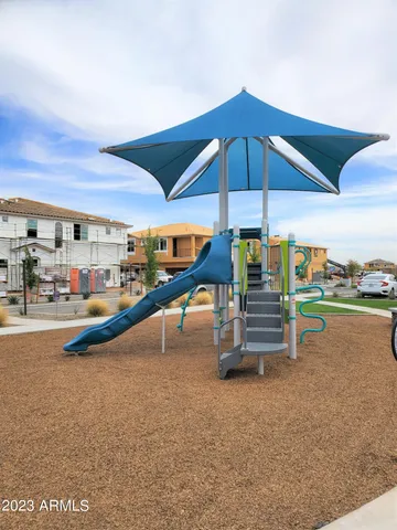 an outdoor space with swimming pool table and chairs