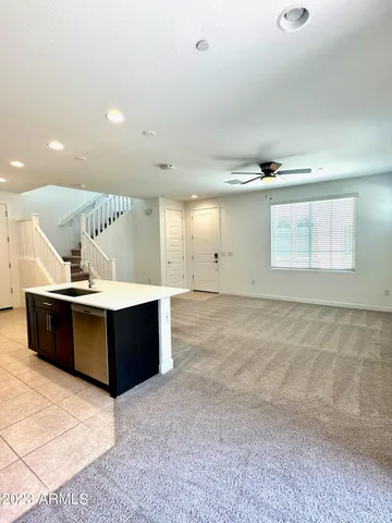 a living room with wooden cabinets and a wooden floor