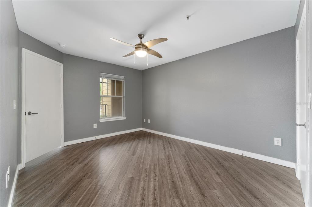 2203 Key W Court, Unit 422 Kissimmee, FL 34741 - Photo 12 of 41 a view of empty room with wooden floor and fan