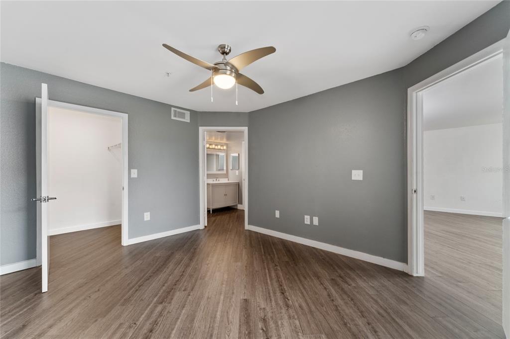 2203 Key W Court, Unit 422 Kissimmee, FL 34741 - Photo 13 of 41 wooden floor in an empty room with a window