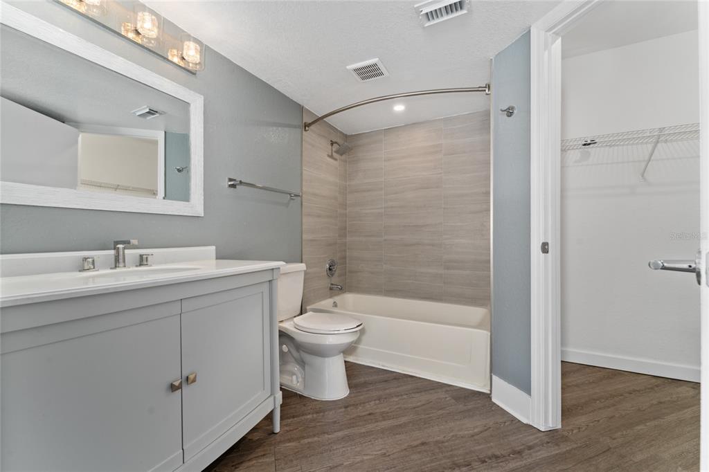 2203 Key W Court, Unit 422 Kissimmee, FL 34741 - Photo 16 of 41 a bathroom with a bathtub shower sink mirror and toilet