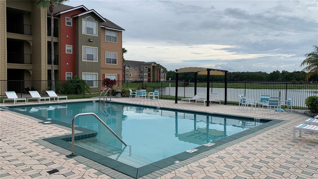 2203 Key W Court, Unit 422 Kissimmee, FL 34741 - Photo 38 of 41 a view of a swimming pool with a lounge chairs