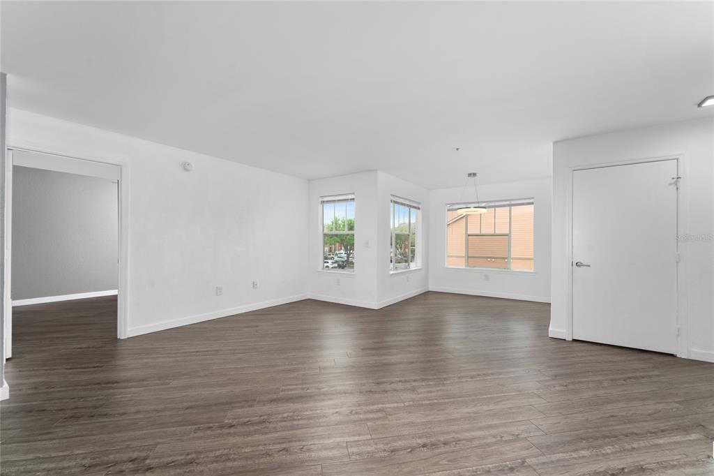 2203 Key W Court, Unit 422 Kissimmee, FL 34741 - Photo 5 of 41 an empty room with wooden floor and windows