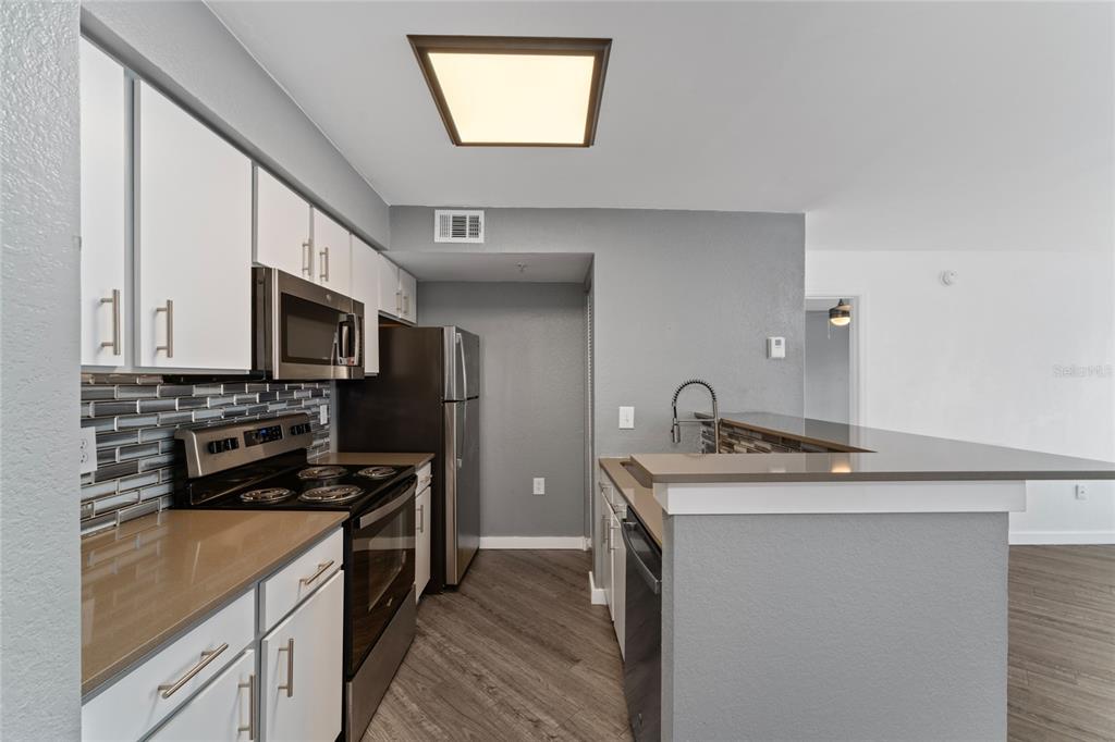 2203 Key W Court, Unit 422 Kissimmee, FL 34741 - Photo 8 of 41 a kitchen that has a sink and a stove top oven