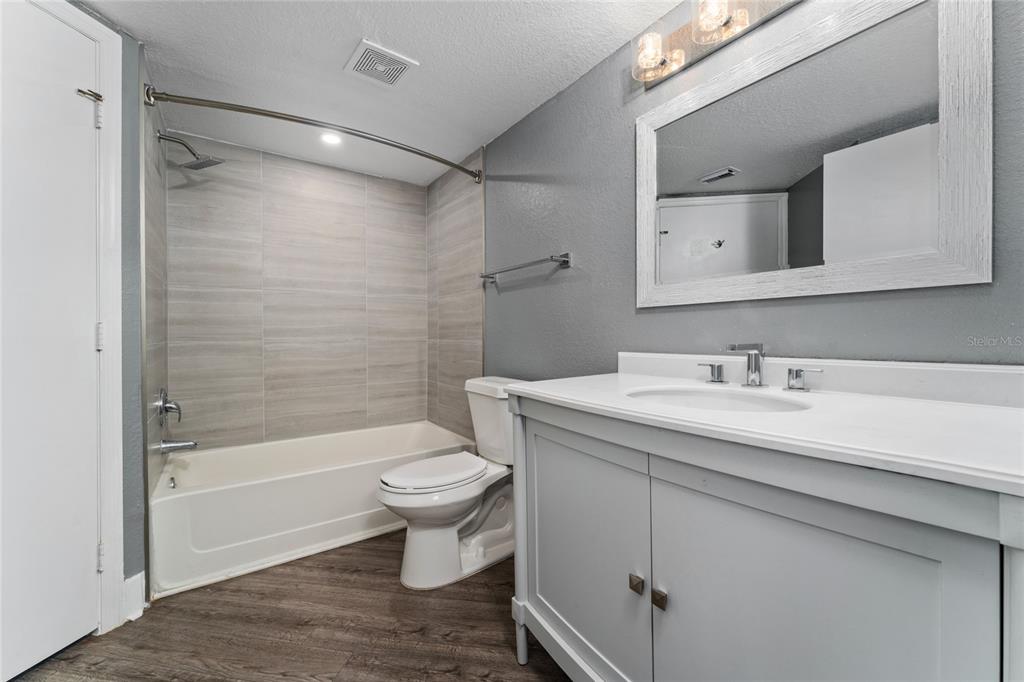 2203 Key W Court, Unit 422 Kissimmee, FL 34741 - Photo 10 of 41 a bathroom with a granite countertop sink toilet and shower