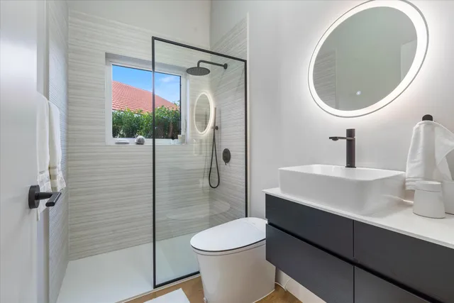 a bathroom with a sink toilet and shower