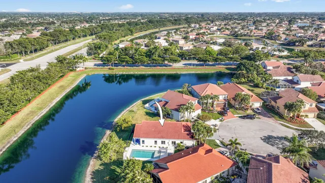 an aerial view of a house with a lake view