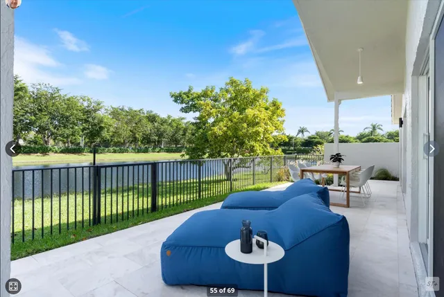 a view of a patio with table and chairs with wooden fence